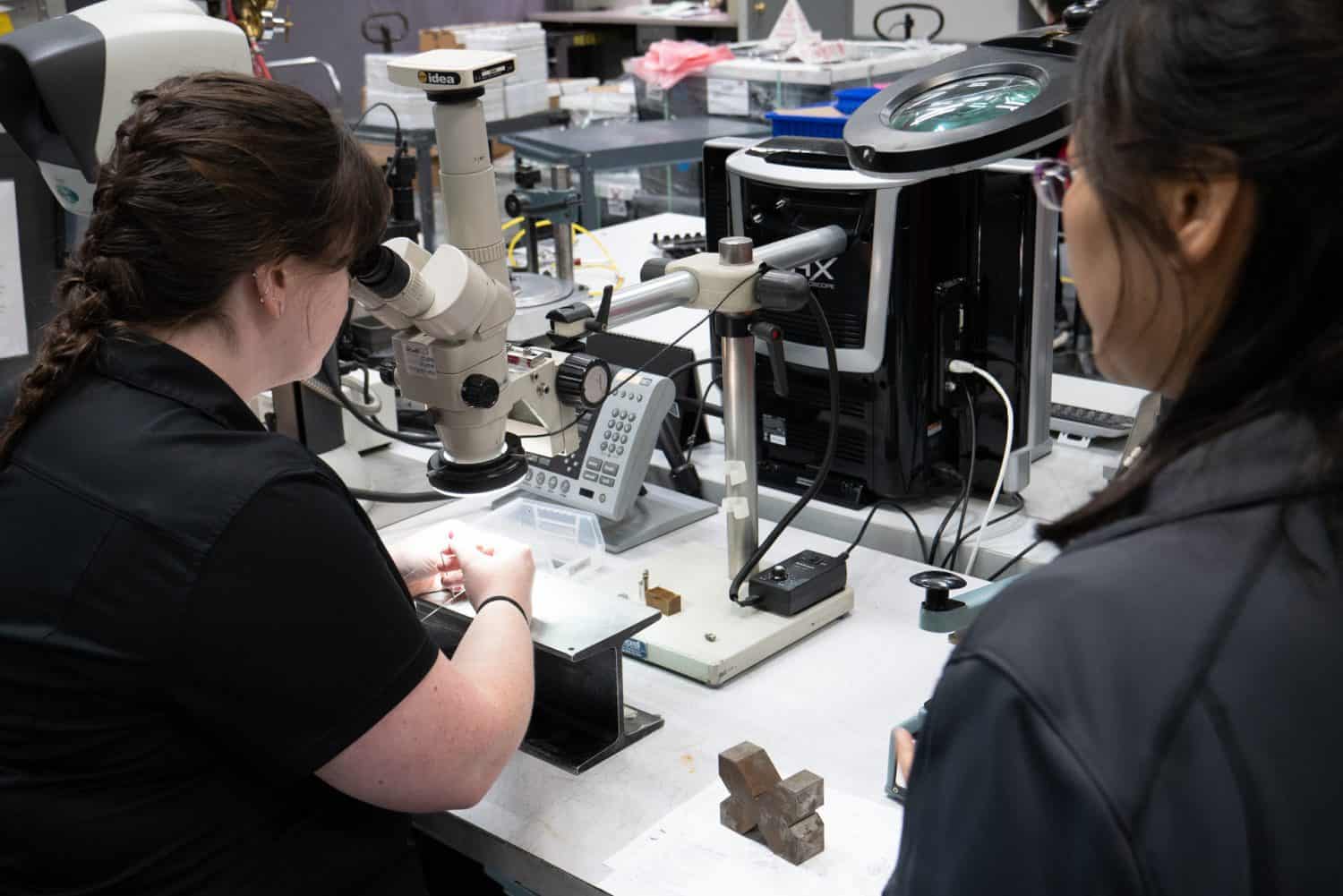 Engineering staff examine welds.